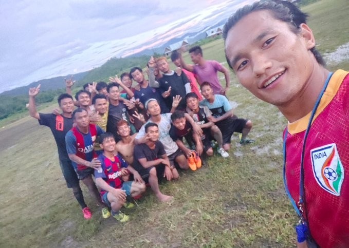 Seiminlen Doungel takes a selfie with his ‘trainees’ at the Longja village ground in Manipur’s Chandel district. (IANS Photo)